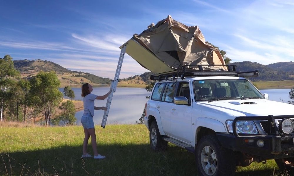 person showing you how to set up your rooftop tent