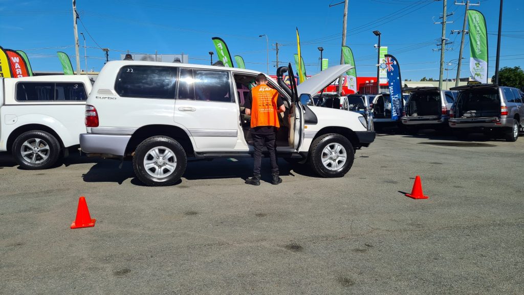 one of our queensland inspectors carrying out a pre purchase car inspection at a car dealership
